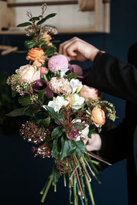 Close-up of hand holding flowering plant