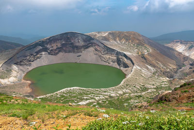 Okama crater lake at mount zao in summer sunny day. active volcano in miyagi prefecture, japan