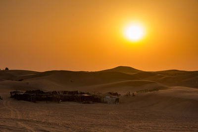 Scenic view of desert against sky during sunset