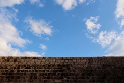 Low angle view of wall against sky