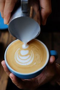 Cropped image of person preparing coffee 