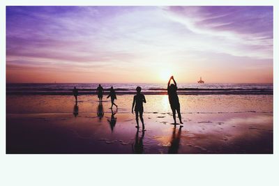 Silhouette men on beach against sky during sunset