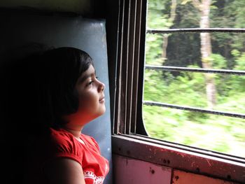 Child looking through window