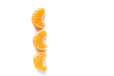 Close-up of orange fruit against white background