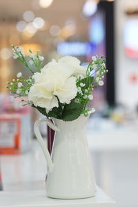 Close-up of white flower vase on table