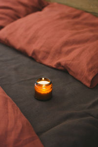 Close-up of wristwatch on bed