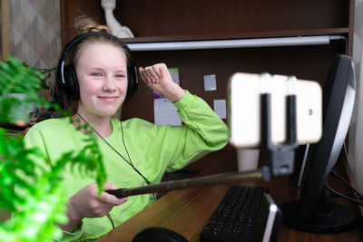 Portrait of smiling girl using mobile phone