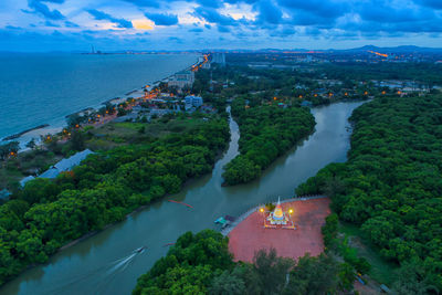 High angle view of cityscape by sea against sky