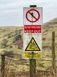 Close-up of warning sign on land