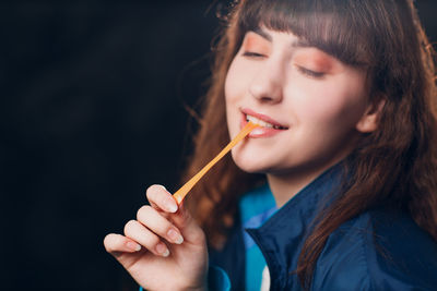 Close-up of young woman drinking water