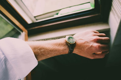 Close-up of hand holding clock