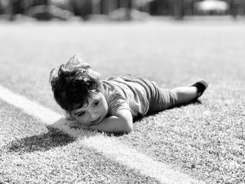 Portrait of boy lying on the soccer field