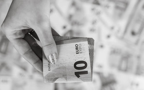 Cropped hand holding paper currency