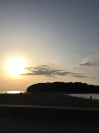 Scenic view of beach against sky during sunset