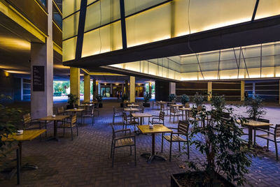 Empty chairs and tables in restaurant