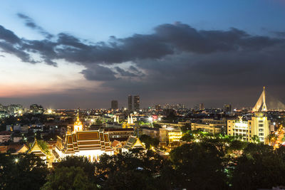 View of cityscape against cloudy sky