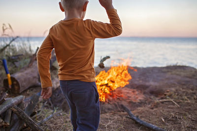 Rear view of man standing on beach