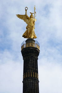 Low angle view of victory column against cloudy sky