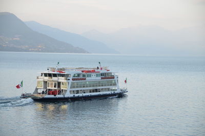 Scenic view of ferry on lake against sky