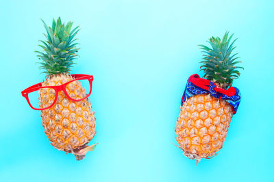 Close-up of fruits against blue background