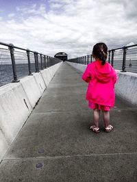 Full length of girl standing against clear sky