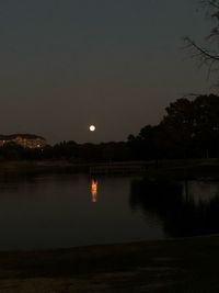 Scenic view of lake against sky at night