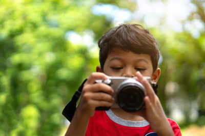 Close-up of boy photographing