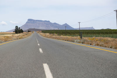 Surface level view of country road against sky