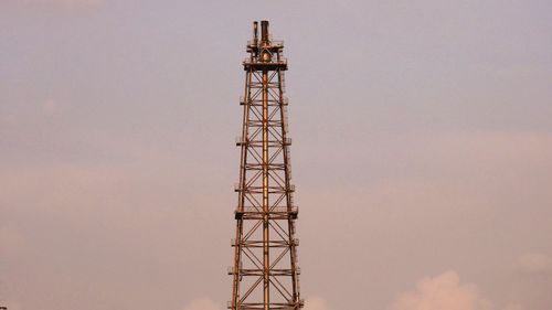 Low angle view of communications tower against sky