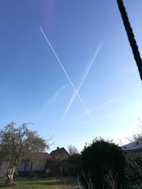 Low angle view of vapor trails in sky