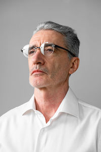 Man standing against gray background