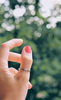 Close-up of woman hand against blurred background