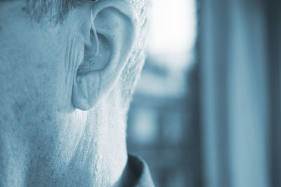 Close-up of man with hearing aid