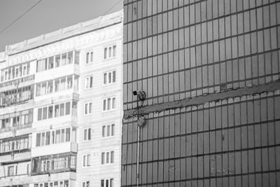 Low angle view of bird perching on building