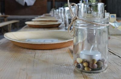 Close-up of place settings and jar on table