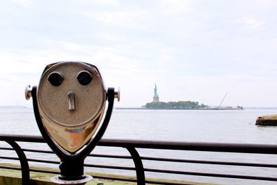 Close-up of coin-operated binoculars by sea 