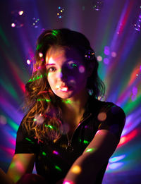 Portrait of woman in illuminated nightclub