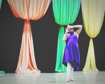 Rear view of a woman standing in curtain