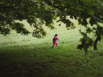 Full length of girl walking on field