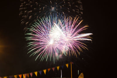 Low angle view of firework display at night