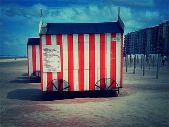 Close-up of red flag against cloudy sky