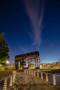 Illuminated built structure against blue sky