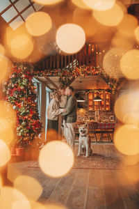 Candid authentic happy family during wintertime together enjoying holidays with dog at xmas