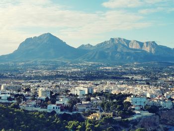 High angle view of townscape and mountains against sky