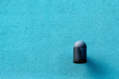 High angle view of blue paint on table against wall