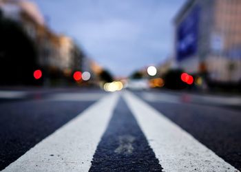 Close-up of road against sky in city