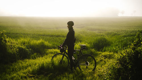 Man riding bicycle on field