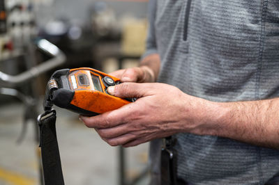 Midsection of man working in workshop