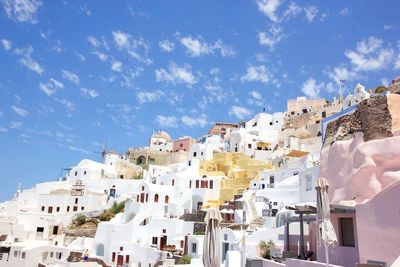 Low angle view of buildings in town against sky