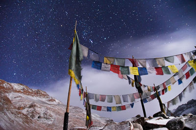 Panoramic view of traditional buddhist prayer flags against sky at night